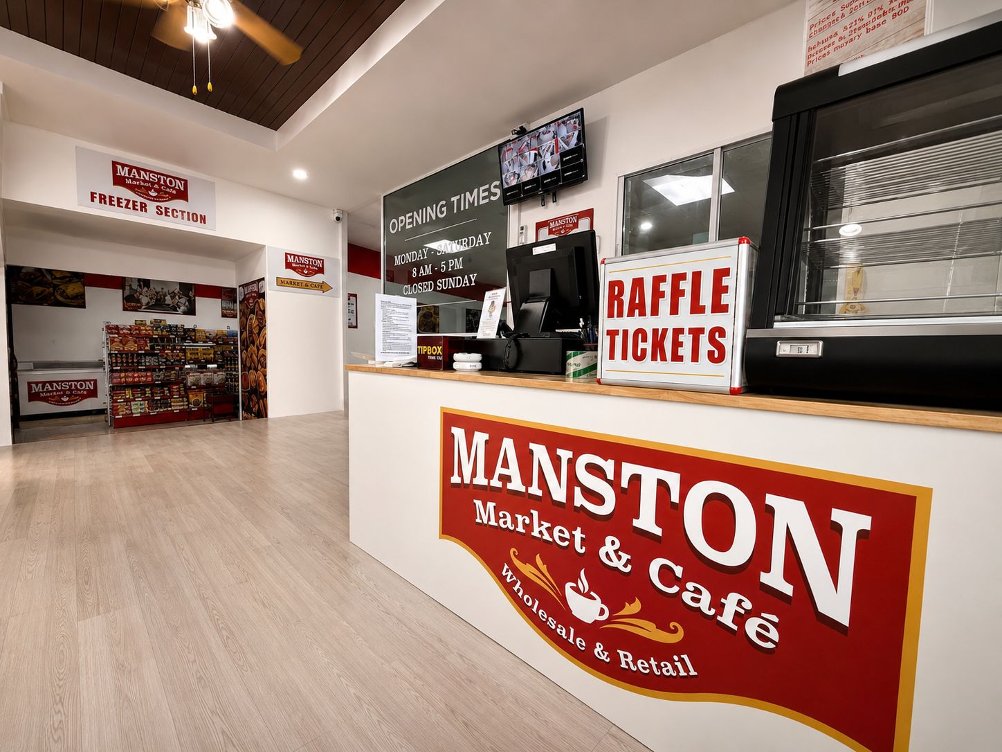 The Manston Market & Café service counter with the brand logo and opening times