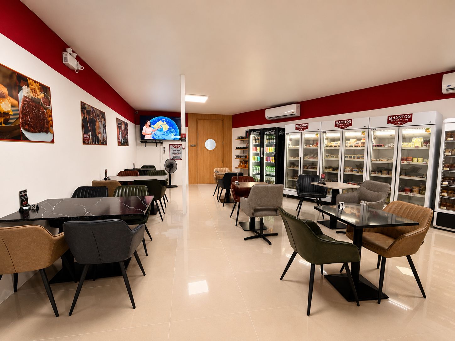 A cosy corner of the Manston café with leather chairs and marble tables